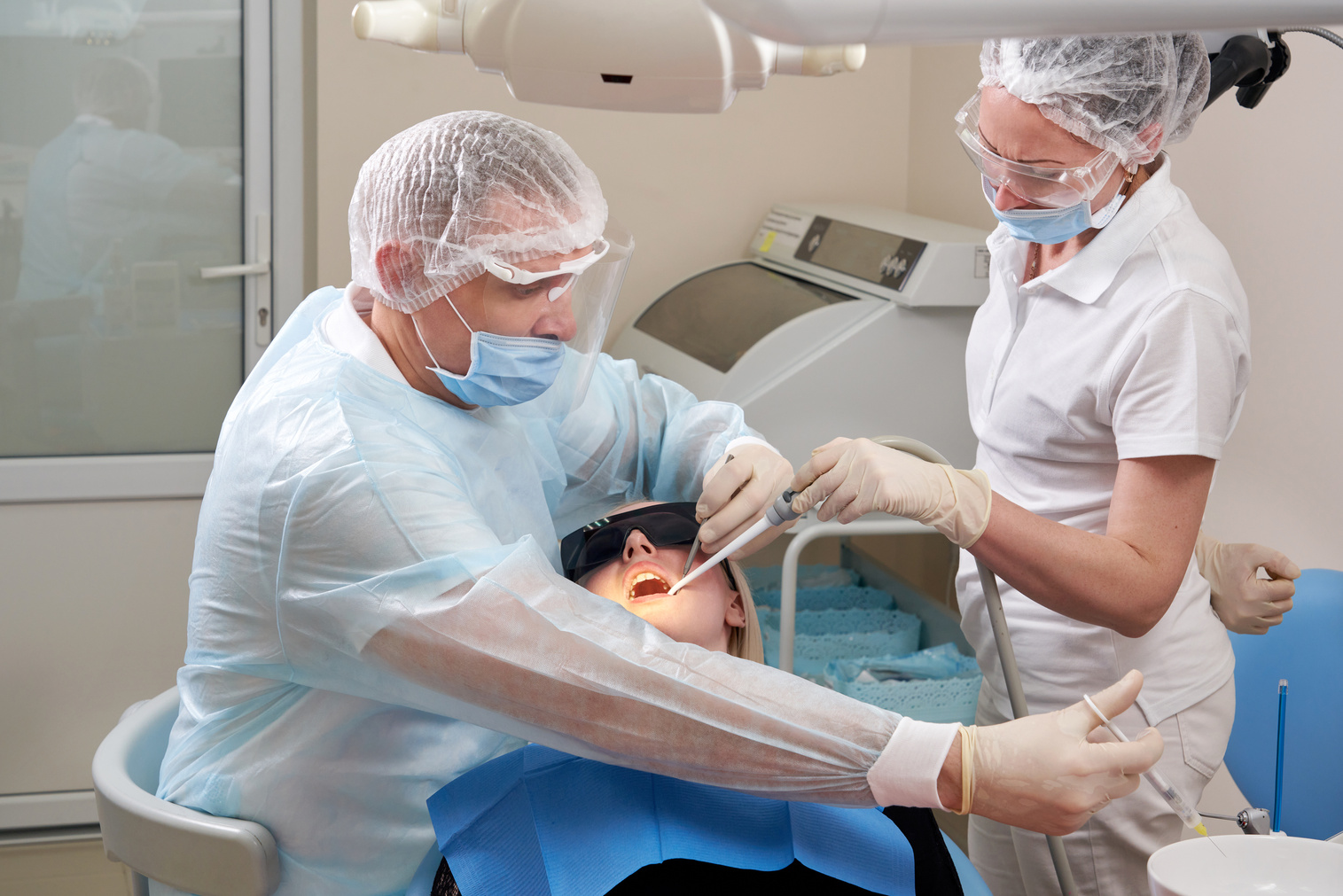 Dentist making local anesthesia shot before surgery.